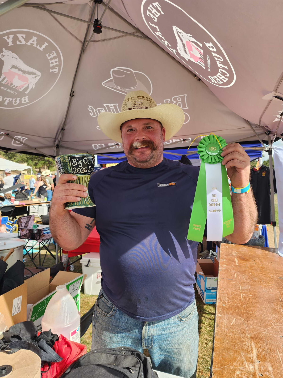 Evan Jeffries with The Lazy Butcher first-place green chile ribbon