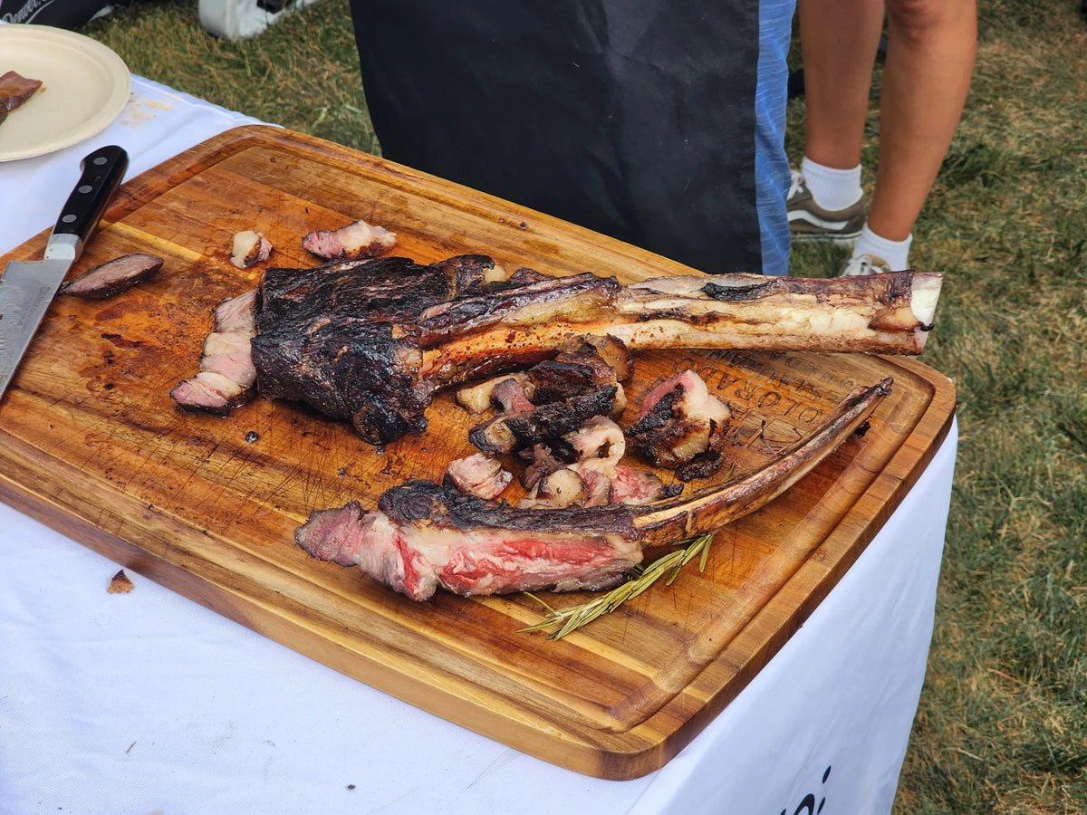 Tomahawk steaks over open flame at the Colorado Beef Festival, presented by the Colorado Beef Council