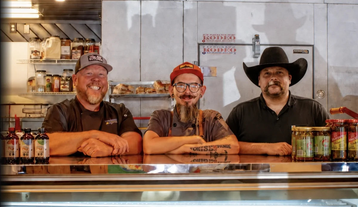 Photo of the Lazy Butcher crew hanging out at the butcher case