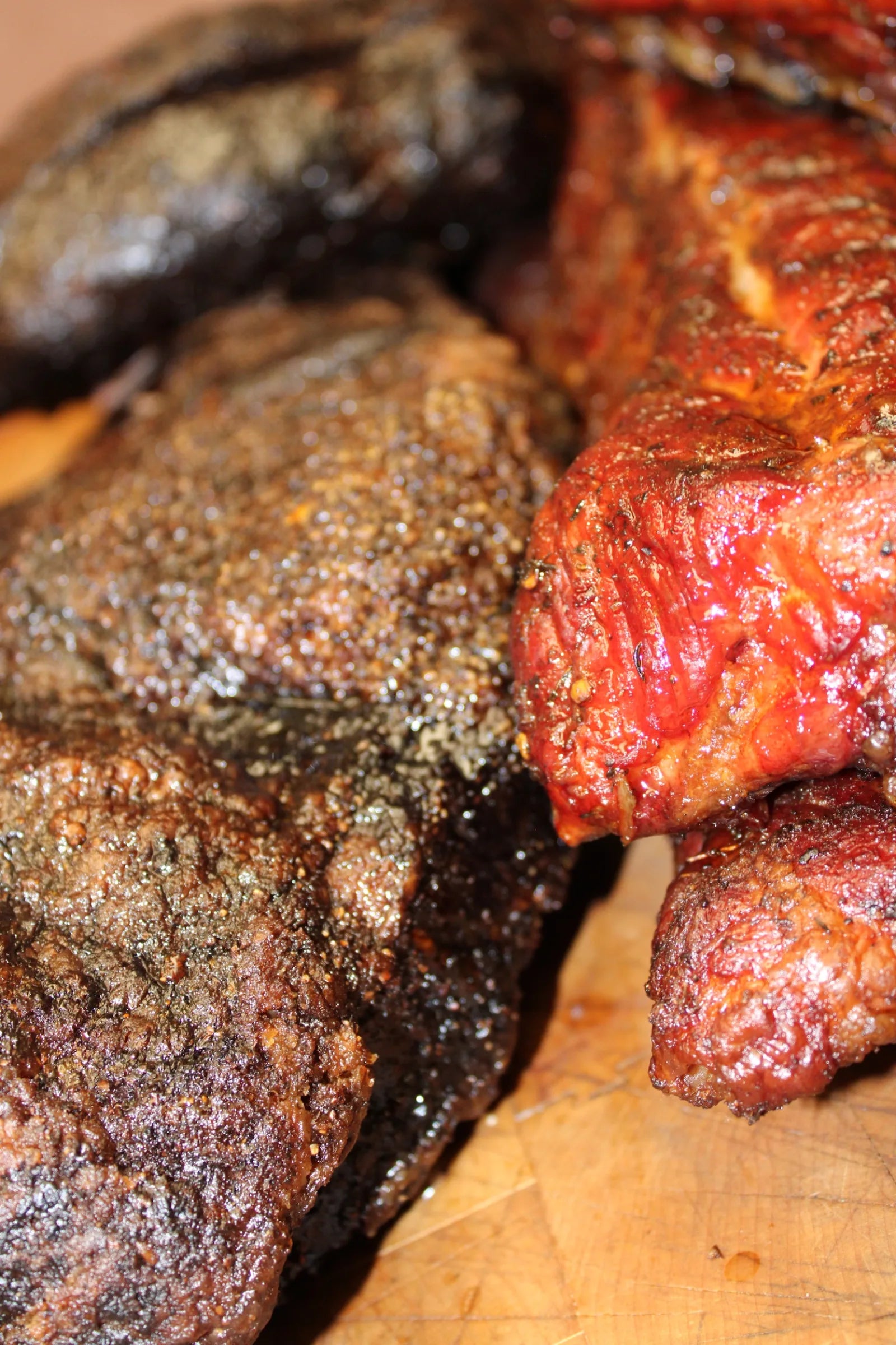 Close-up of smoked brisket with a dark peppery bark, fresh off the smoker