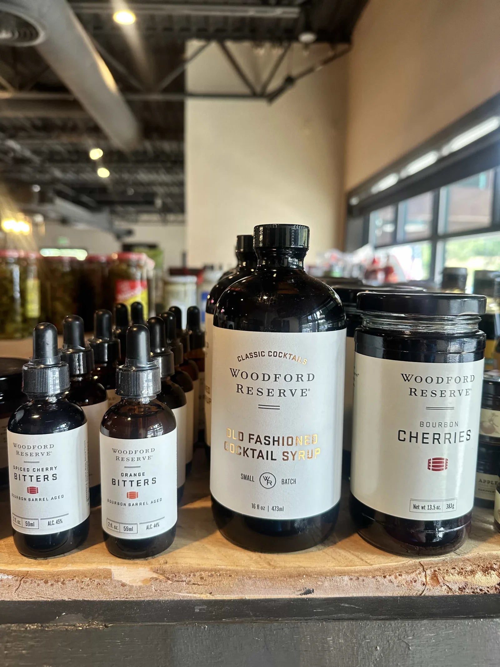Woodford Reserve bitters, cocktail syrup, and bourbon cherries on the shelf