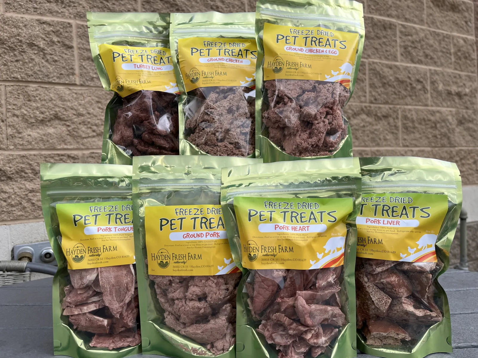 Bags of Hayden Fresh Farm freeze-dried pet treats — pork tongue, ground pork, pork heart, and pork liver