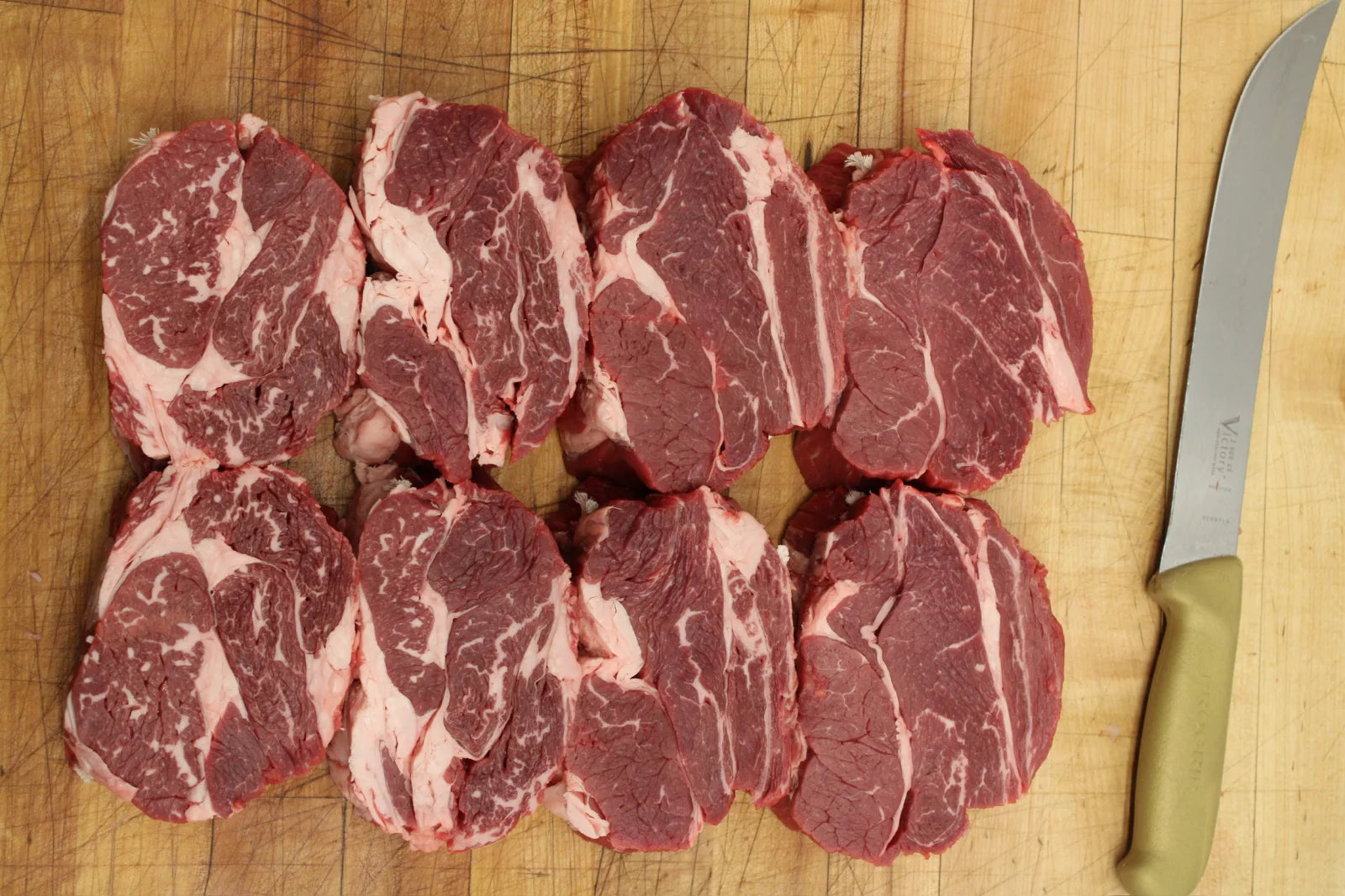 Freshly portioned ribeye steaks at the butcher case