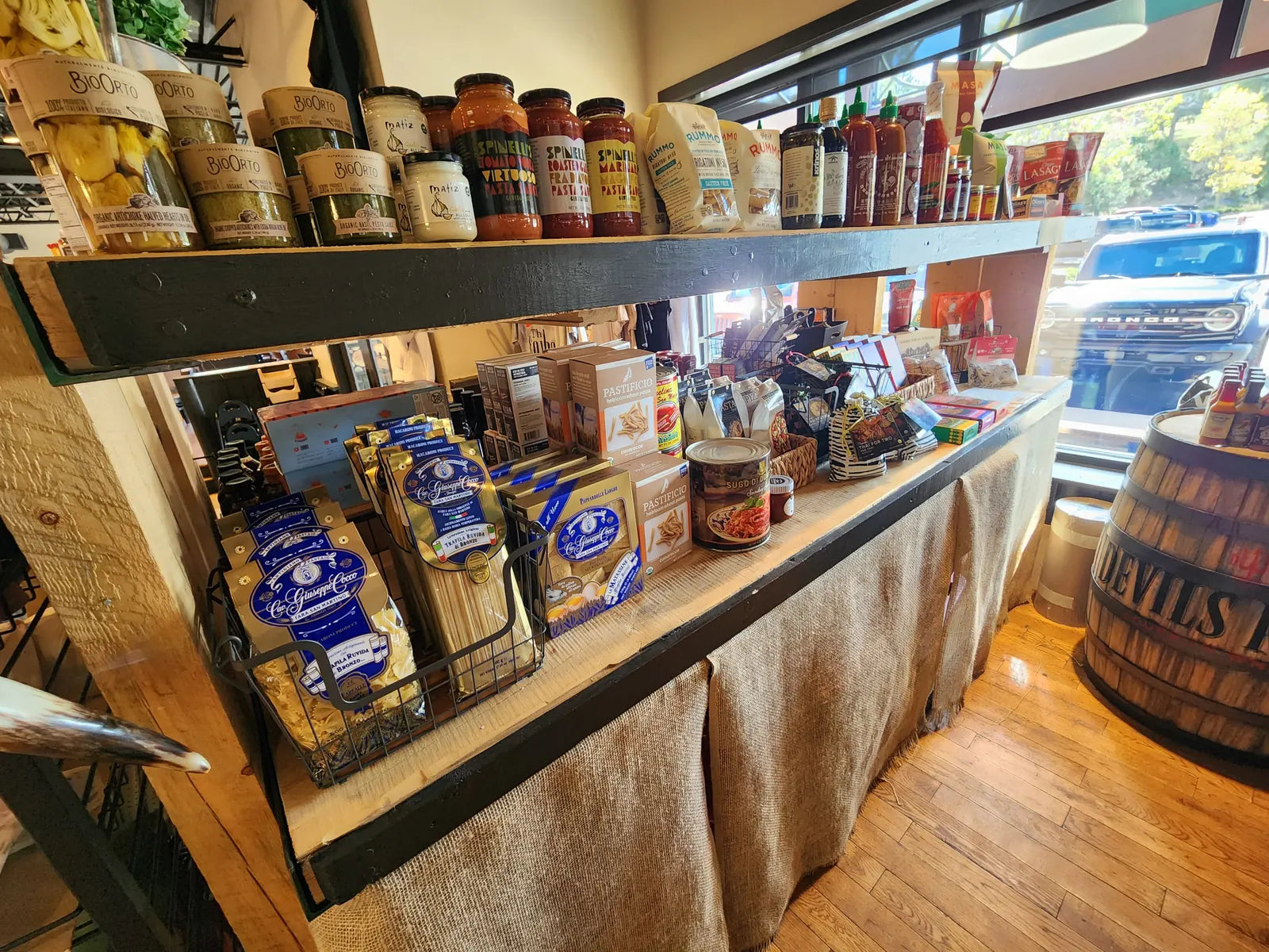 Shelves of imported Italian pasta, organic pasta sauces, artichoke hearts, and hot sauces